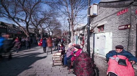 The old sit in the sun watching the visitors passing by the Nanluogu alley 스톡 동영상 36449948