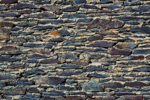Old slate wall background with different colors Stock Photos