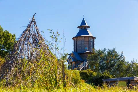 Old Slavic tower of the Sun in the old village. Wooden religious pagan tower  Stock Photos