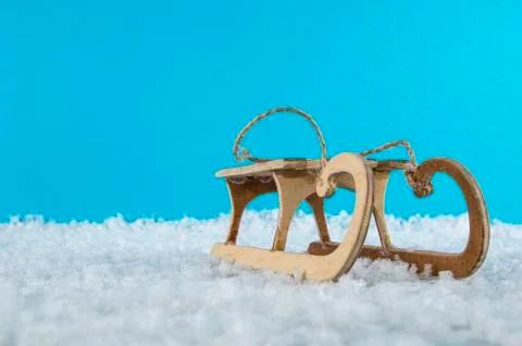 Old sled in the snow, blue background Stock Photos
