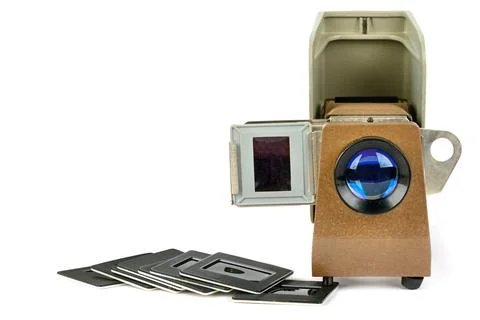Old slide projector and set of slides isolated on white background. Free sp.. Stock Photos