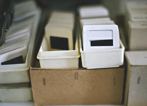 Old slides. Selective focus on slides. Blurred background with boxes and slid Stock Photos