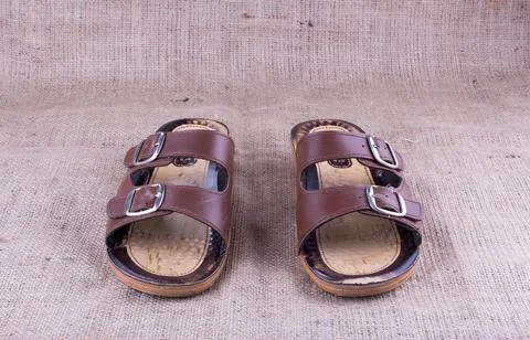 Old slippers on burlap Foto stock