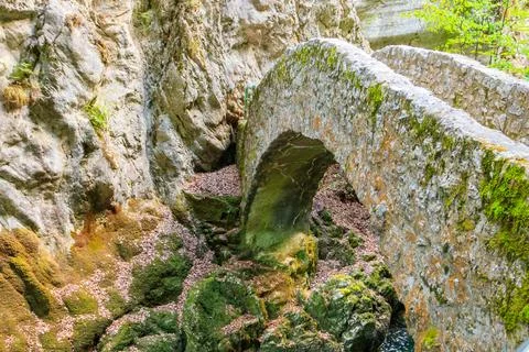 Old small stone bridge over river at Gorges de l'Areuse, Switzerland Stock Photos