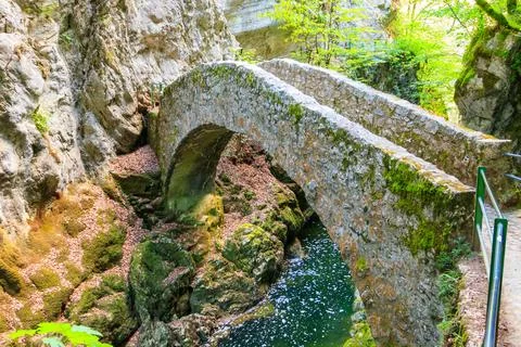 Old small stone bridge over river at Gorges de l'Areuse, Switzerland Stock Photos