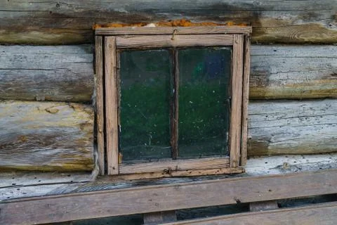 Old small wooden window in a rustic bath. Stock Photos