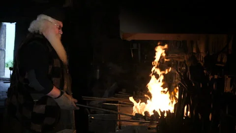 An old smith is working in a smith Video stock 103868758