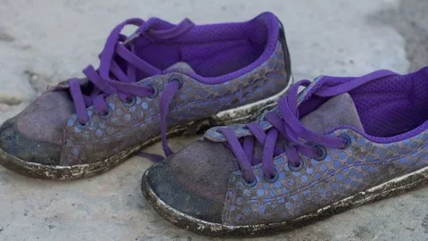 Old sneakers on the ground Stock Footage 70222789