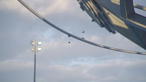Old sneakers hanging off of the Flushing Meadows Unisphere Stock Footage 317155878