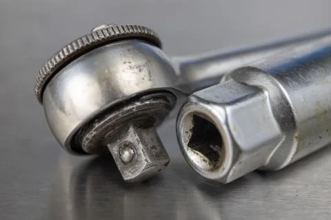 Old socket wrenches with a handle. Accessories for a workshop mechanic on a t Stock Photos