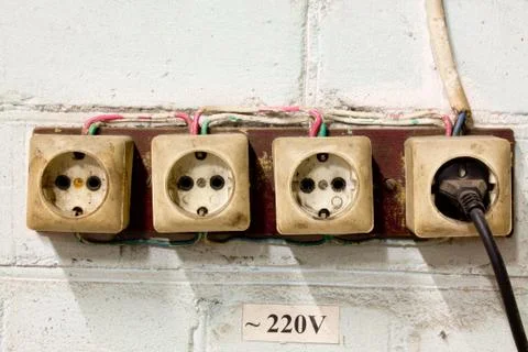 Old sockets with plug on the wall Stock Photos