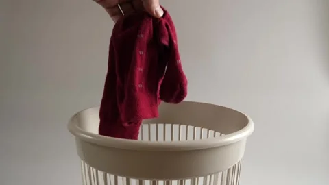 Old socks are thrown into the trash for recycling. Slow motion. Stock Footage 261167539