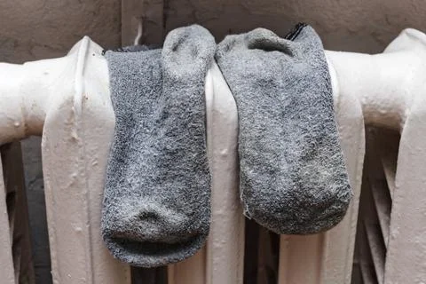 Old socks to dry on battery Stock Photos