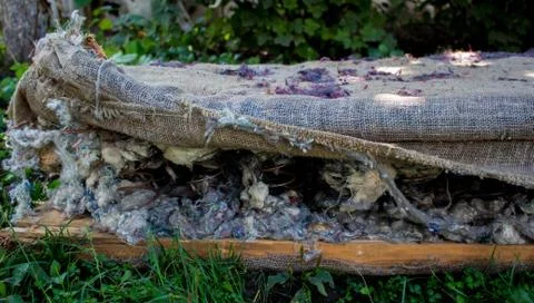 A old sofa with a spring in the ground Stock Photos
