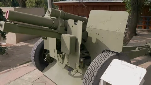 Old soviet 122mm howitzer is standing for display in a yard of Military museum Stock Footage 318718247
