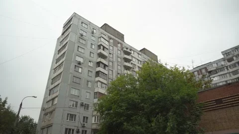 An old Soviet building against the backdrop of gray clouds. Bottom view of an Stock Footage 219598608