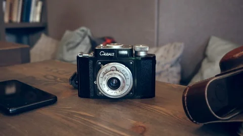 Old soviet camera on table, loop Stock Footage 111836973
