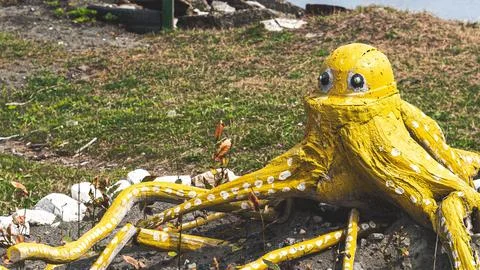 Old soviet decorations made of old tires octopus yellow handmade craft ugly Stock Photos