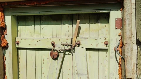 Old Soviet-Era Lock Secures Weathered Wooden Door With Chain – Rustic Security Stock Footage 310315481