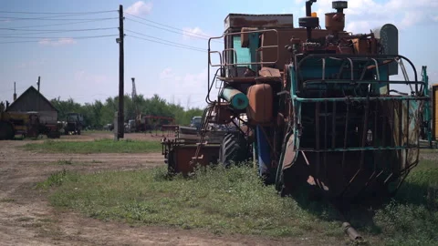 Old soviet harvester stand broken on the collective farm Stock Footage 119495832