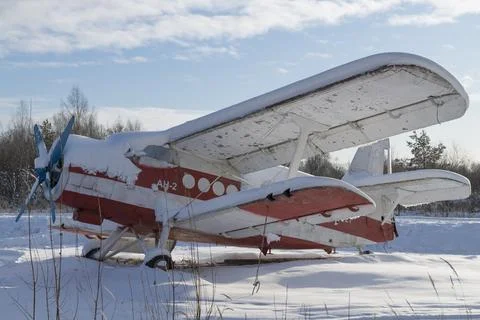 An old Soviet plane of the An-2 under the snow on a frosty January day 写真素材