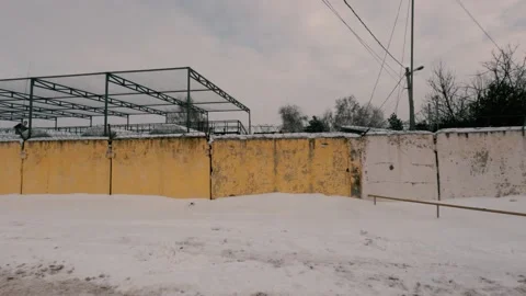 Old Soviet prison in winter, high fence with barbed wire and snow Stock Footage 167953615