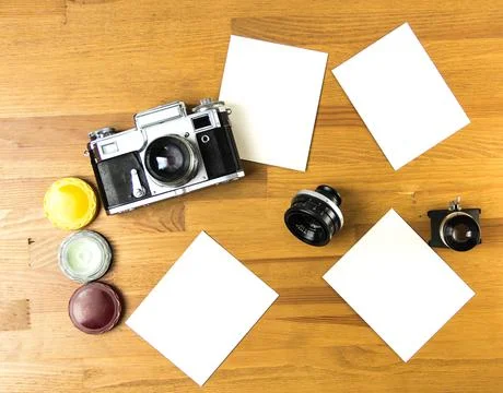 Old soviet rangefinder analog camera top view on an old table with film. Stock-Fotos