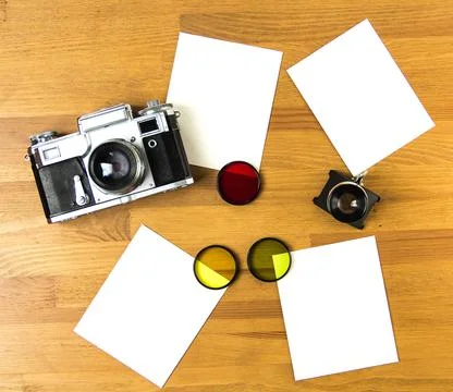Old soviet rangefinder analog camera top view on an old table with film. Stock Photos