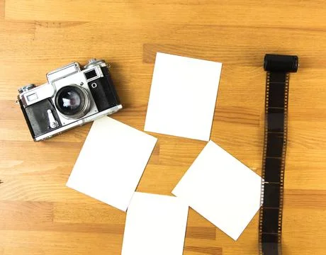 Old soviet rangefinder analog camera top view on an old table with film. Stock Photos