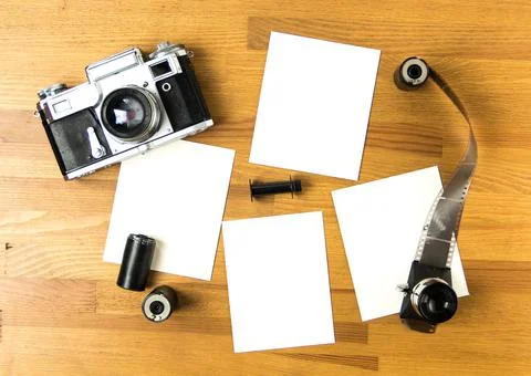 Old soviet rangefinder analog camera top view on an old table with film. Stock Photos