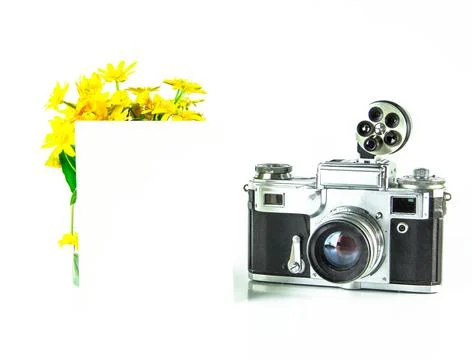 Old Soviet rangefinder analog camera with a bouquet of flowers. Stock Photos