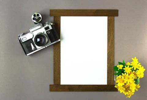 Old Soviet rangefinder analog camera with a bouquet of flowers. Stock Photos