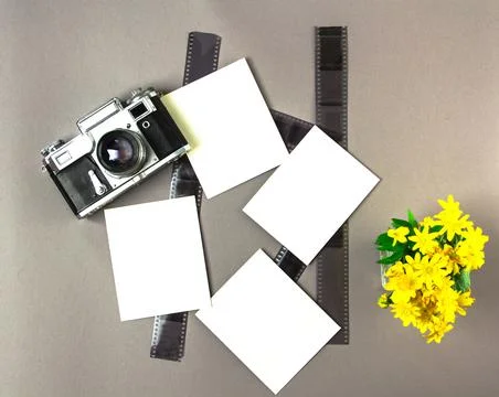 Old soviet rangefinder analog camera top view on an old table with film. Stock Photos