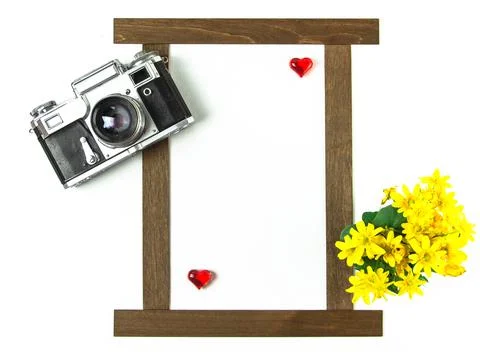 Old Soviet rangefinder analog camera with a bouquet of flowers. Stock Photos