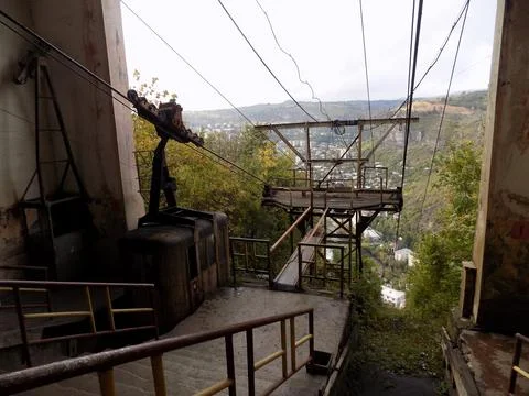 Old soviet ropeway, platform and cable car cabin above the city Stock Photos