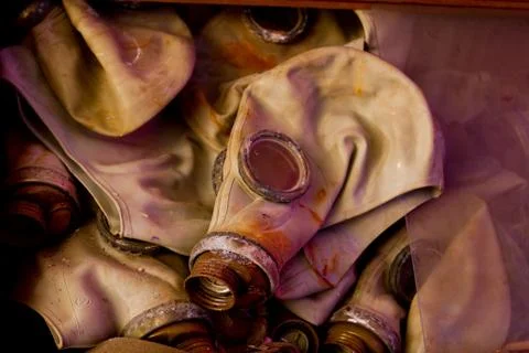 Old soviet rubber masks lying in a warehouse Stock Photos