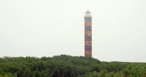 Old soviet rusty lighthouse at foggy dawn. Stock Footage 231220087