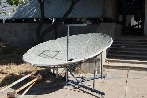 An old Soviet satellite antenna stands in the sun Stock Photos