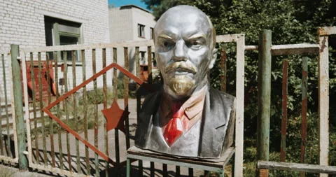 Old soviet sculpture of lenin in front of abandoned building in Chornobyl Stock Footage 138992551