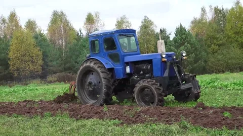 Old Soviet Tractor running And Plowing the field Stock Footage 239678972