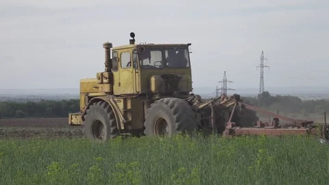 Old soviet tractors working in the field. 4k. Flat pikture profile Stock Footage 75815707