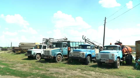 Old soviet trucks stand broken on the collective farm Stock Footage 119495521