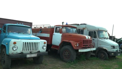 Old soviet trucks stand broken on the collective farm Stock Footage 119495669