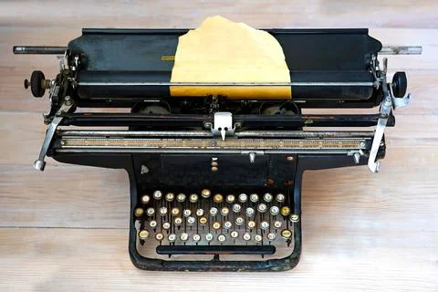 An old Soviet typewriter with keys with Russian letters and a sheet of yellow Stock Photos