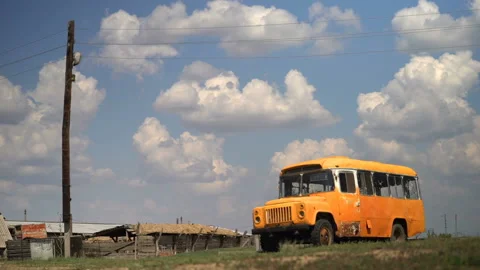 Old soviet yellow bus kavz 685 stand broken on the collective farm Stock Footage 119495889