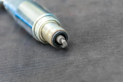 Old spark plug in key, selective focus Stock Photos