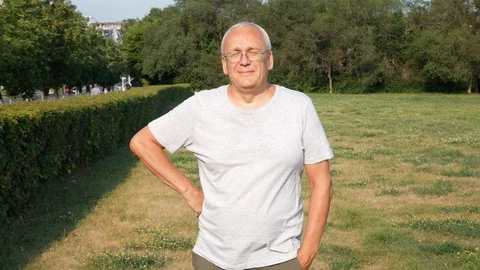 An Old Spectacled Man Staring at Camera Laughing and Smiling Stock Footage 114652621