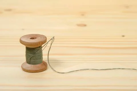 The old spool of thread with a needle. Stock Photos