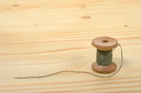 The old spool of thread with a needle. Stock Photos