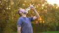 The old sportsman drinking a water. slow motion 4k or 4k+ Resolution